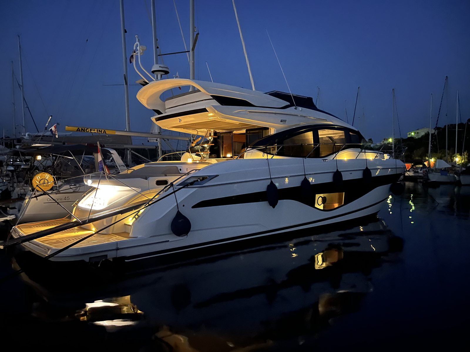 Aexea at berth in the marina after sunset
